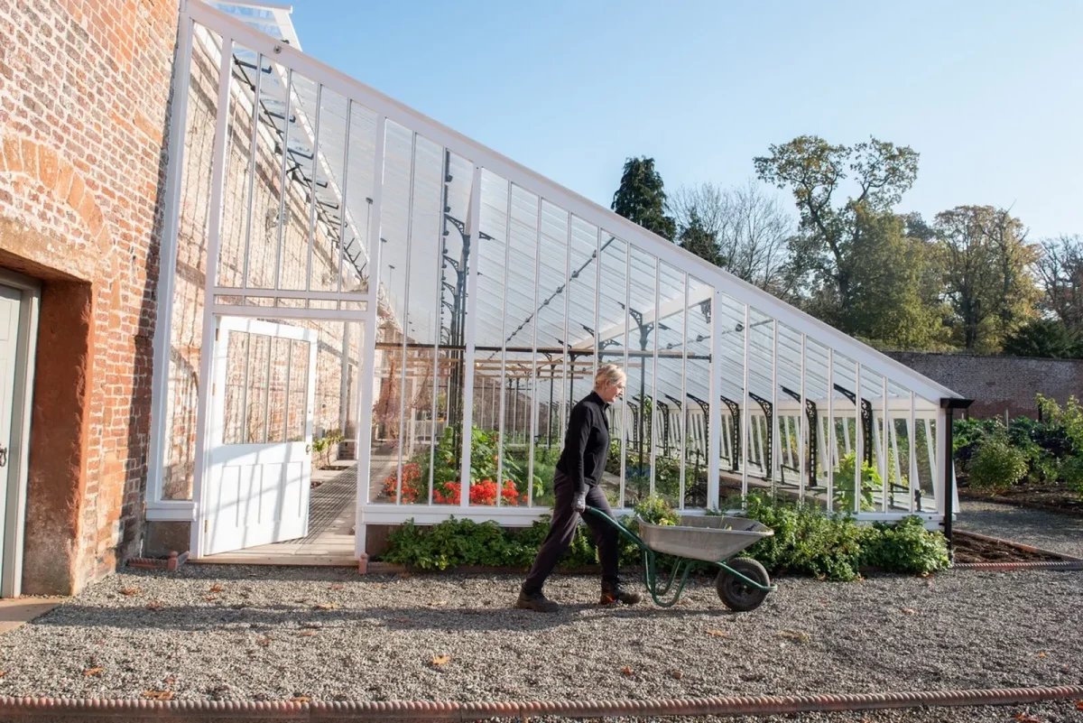 Traditional Victorian Glasshouses Walled Garden Woman with Wheelbarrow