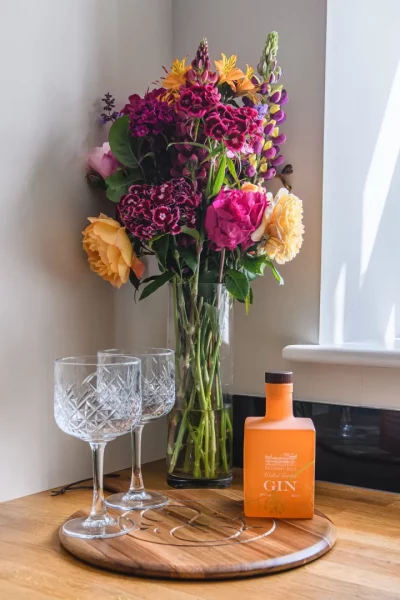 Beautiful Flowers near window with Gin and Glasses in Sir Walter Scott 2 Bedroom Self Catering Apartment