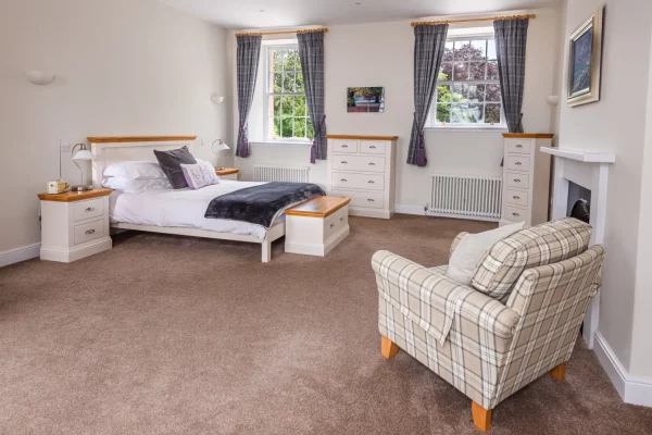 King Size Bed with Window Views and Chair in Sir Walter Scott Apartment