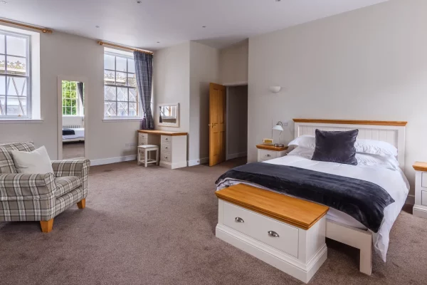 Master Bedroom with King Size Bed and Sofa Chair in Sir Walter Scott Apartment