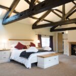 Luxurious bedroom at Netherby Hall with elegant furnishings and a tranquil atmosphere