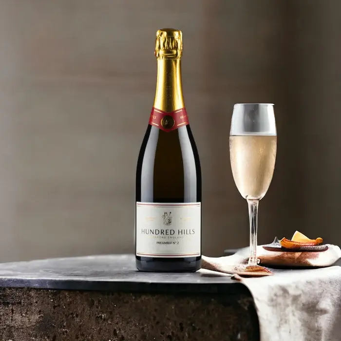A chilled bottle of Hundred Hills sparkling wine alongside a glass, perfect for a romantic celebration.