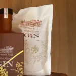 Close-up of Netherby Hall Walled Garden Gin bottle and botanical-themed 50cl refill pouch