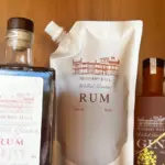 Close-up of Netherby Hall Walled Garden Rum bottle and 50cl refill pouch with spout