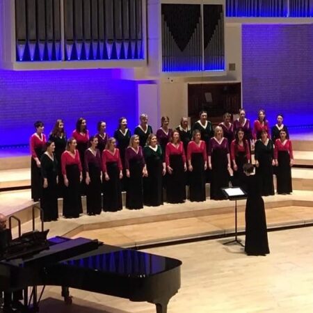 Sempre Amabile choir performing on stage – featured at the Christmas Carols at Netherby Hall 2025 event
