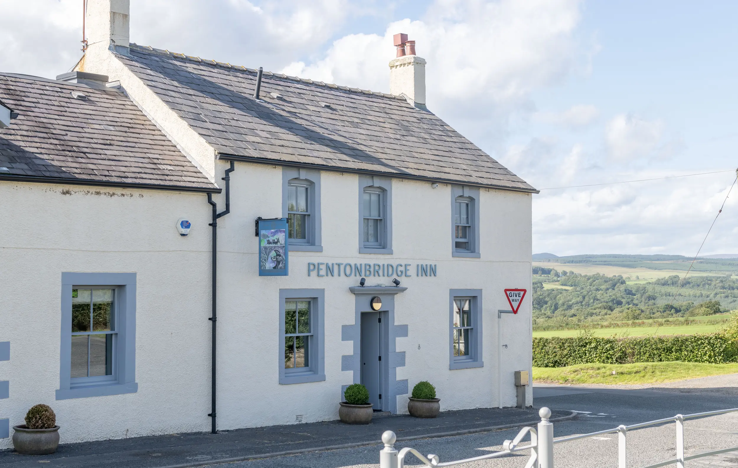 Exterior view of Pentonbridge Inn, a Michelin-starred restaurant near Netherby Hall, showcasing its charming facade and scenic surrounding countryside in Cumbria, UK. Ideal for guests seeking luxury self-catering accommodation and fine dining experiences.