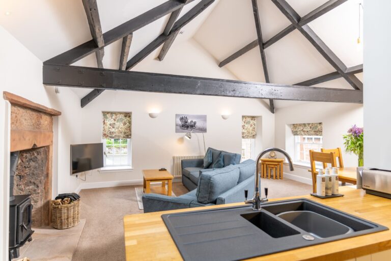 Modern open plan living area and kitchen in the Clock Tower Apartment, luxury self-catering accommodation at Netherby Hall, Cumbria