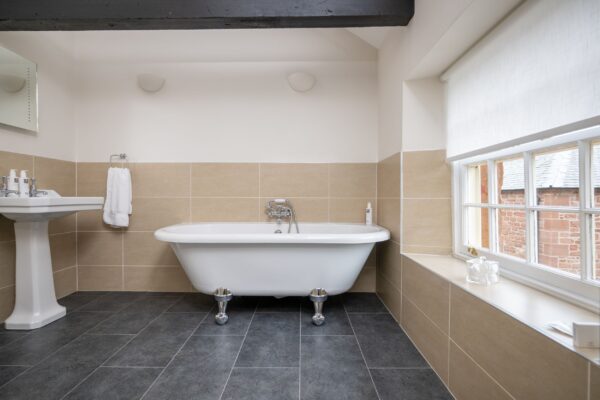Luxury freestanding bathtub in the bathroom of the Clock Tower Apartment at Netherby Hall, Cumbria