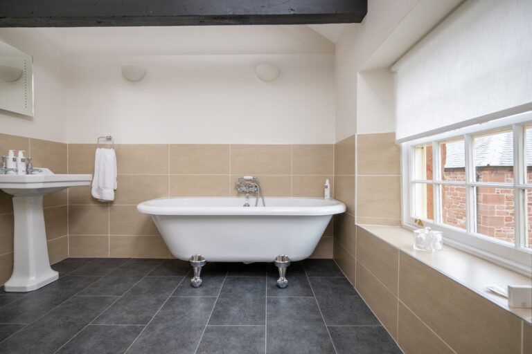 Luxury freestanding bathtub in the bathroom of the Clock Tower Apartment at Netherby Hall, Cumbria