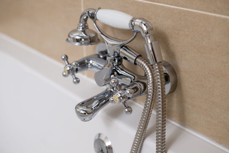 Chrome traditional style bathtub taps and handheld shower attachment in the Clock Tower Apartment at Netherby Hall