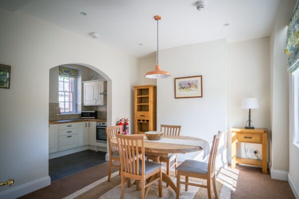 Dining area and kitchen in the Coach House luxury self-catering apartment at Netherby Hall, Cumbria