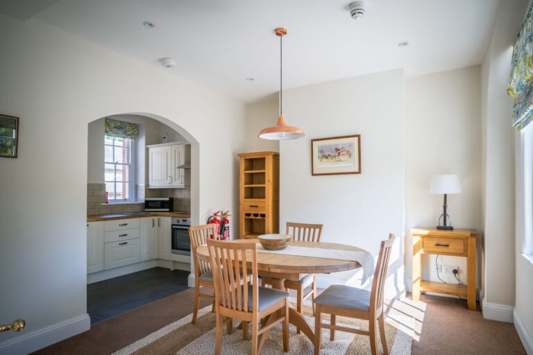 Dining area and kitchen in the Coach House luxury self-catering apartment at Netherby Hall, Cumbria
