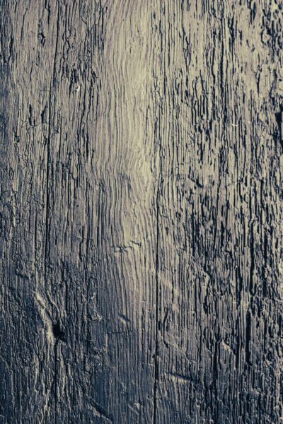 Close-up texture of weathered, dark wood grain in the Engineer Apartment at Netherby Hall
