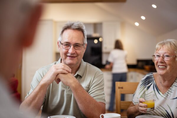 Happy senior couple enjoying breakfast together at Grooms' Quarters, luxury self-catering accommodation at Netherby Hall, Cumbria