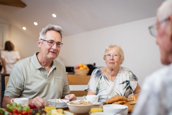 Senior couple enjoying a breakfast of fruit and pastries at Grooms' Quarters, luxury self-catering accommodation at Netherby Hall