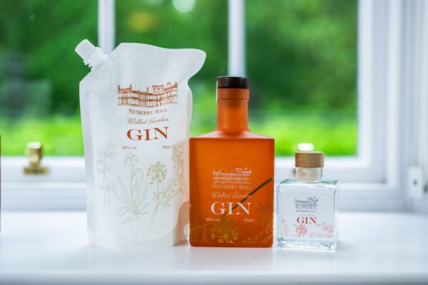 Three bottles of Netherby Hall Walled Garden Gin displayed at the Middle Lodge apartment