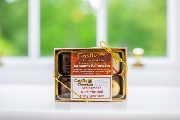 A gift box of Castle Chocolates with a personalized welcome note to Netherby Hall for guests staying in Middle Lodge