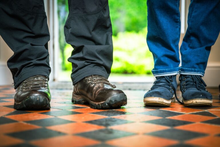 Low angle shot of guests walking across a checkered floor at Middle Lodge, Netherby Hall luxury self-catering accommodation in Cumbria