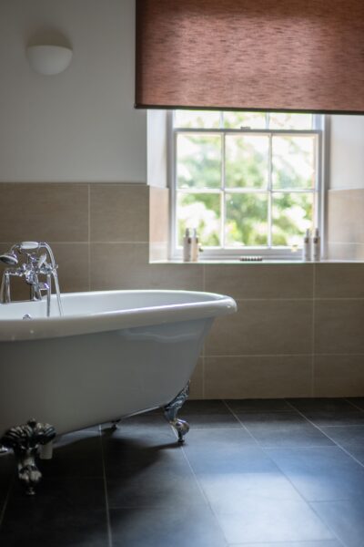 White clawfoot bathtub with silver fixtures in the luxury Salutation Apartment at Netherby Hall, Cumbria