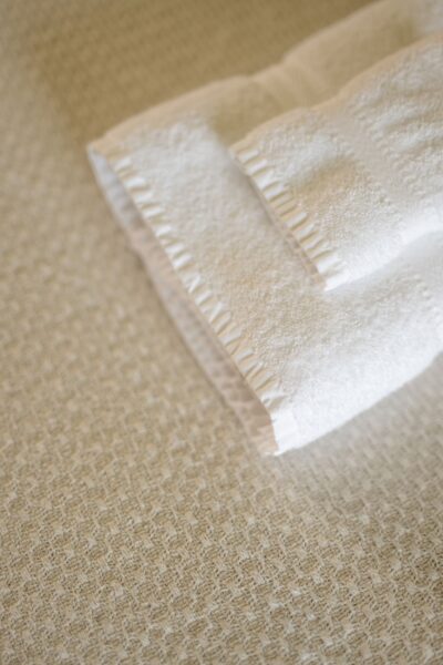 Fresh white towels folded neatly in the Salutation Apartment at Netherby Hall, luxury self-catering accommodation in Cumbria