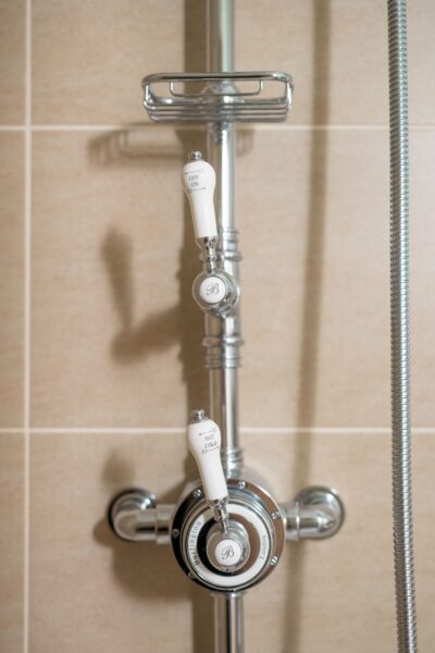 Chrome shower mixer taps with white handles in the luxury Salutation Apartment at Netherby Hall