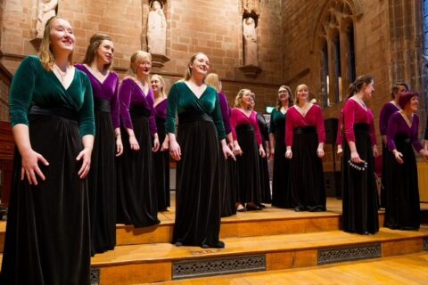 A group of female singers in colorful tops and black dresses performing Sempre Amabile - Absolute Classics Music Concert at Netherby Hall 2026