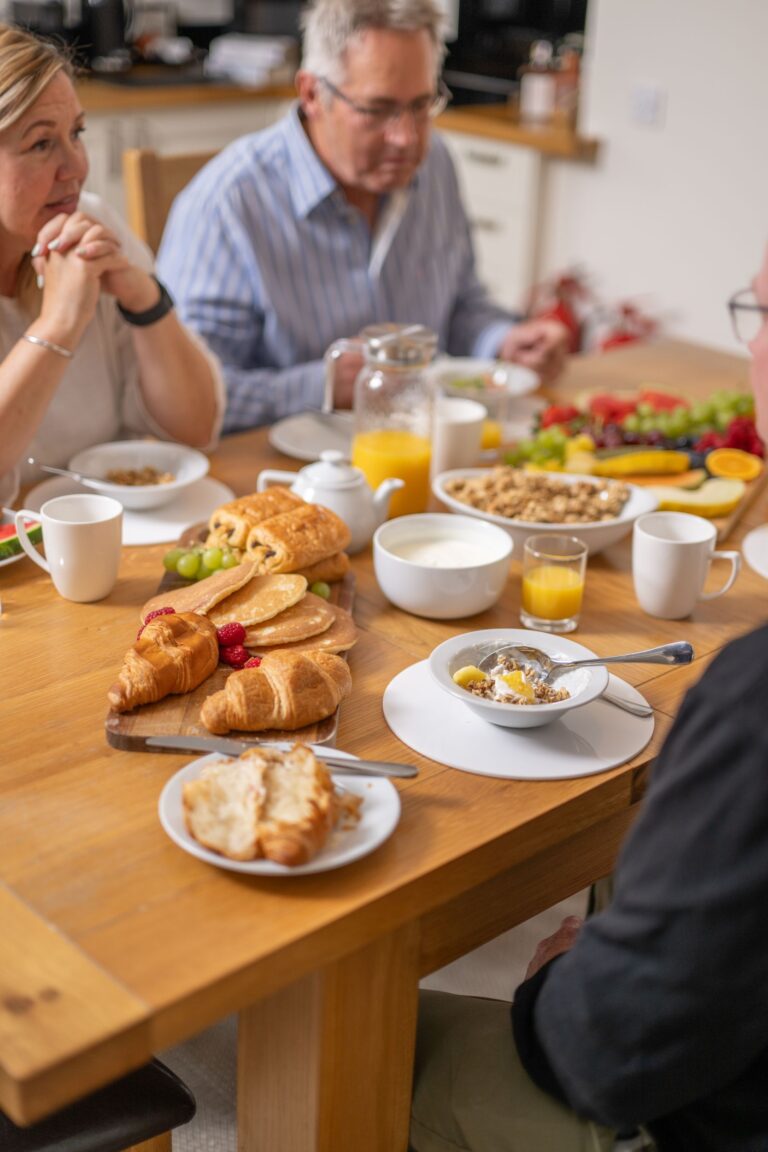 Breakfast spread with pastries, fruit, and juice at the Sir Walter Scott Apartment in Netherby Hall, Cumbria